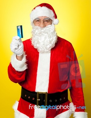 Male In Santa Costume Posing With His Cash Card Stock Photo