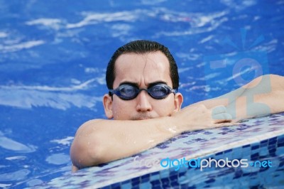 Male Swimmer Resting After Several Laps Stock Photo