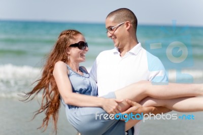 Man Carrying His Girl Friend Stock Photo
