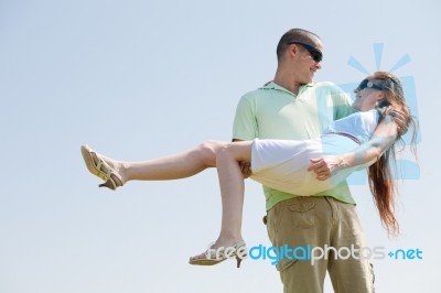 Man Carrying His Girlfriend Stock Photo