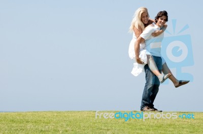 man giving piggy ride to his lover Stock Photo