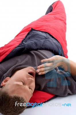 Man In Sleeping Bag And Yawning Stock Photo