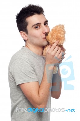 Man Kissing Teddy Bear Stock Photo