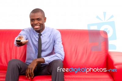 Man On Sofa With Remote Control Stock Photo