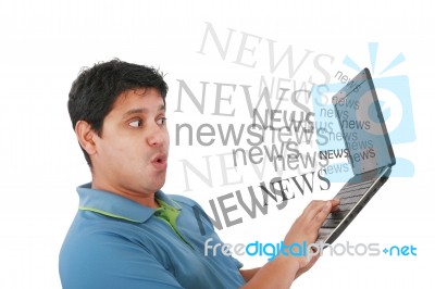 Man Reading News In Laptop Stock Photo