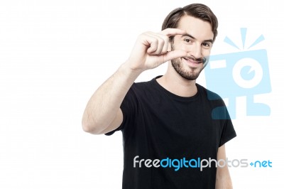 Man Showing Small Amount With Fingers Stock Photo