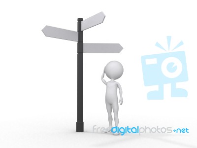 Man Standing Under Direction Board Stock Photo
