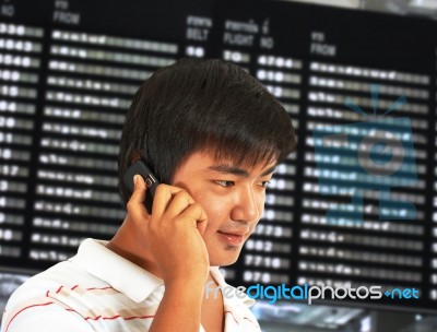 Man Talking On His Mobile Phone In An Airport Stock Photo