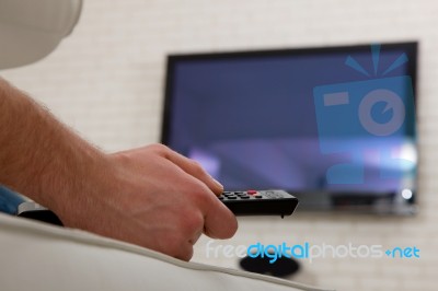 Man Watching Tv With Remote Control Stock Photo