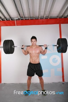 Man With Dumbbell Weight Training Equipment On Sport Gym Stock Photo