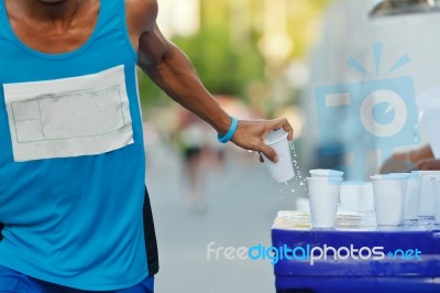 Marathon Racer Holing Cup Of Water Stock Photo