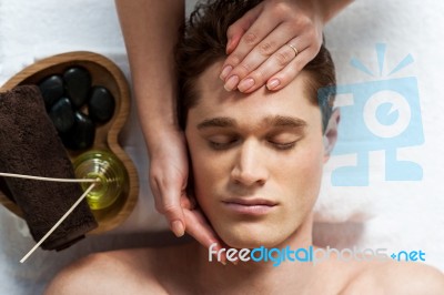 Masseuse Doing Facial Massage Stock Photo