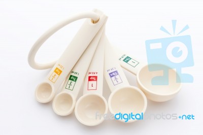Measuring Spoons In Varying Sizes On White Background Stock Photo