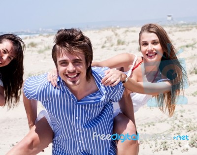 Men Giving Piggy Back To Women Stock Photo