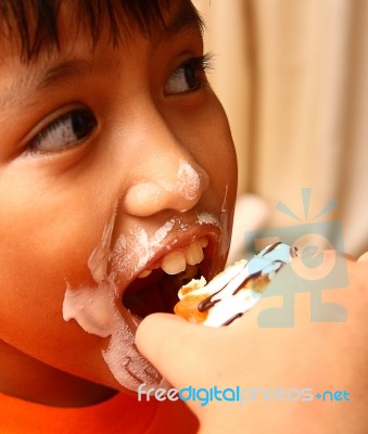 Messy Face Child Eating Cake Stock Photo