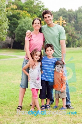 Middle Aged Couple Standing With Their Children Stock Photo