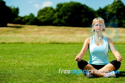 Middle Aged Woman Doing Meditation Stock Photo