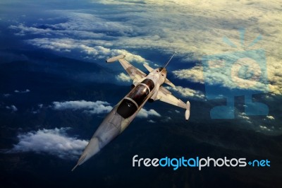 Military Jet Plane Flying Over Mountain Country View Below Stock Photo