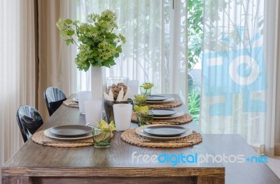 Modern Dinning Room With Wooden Table And Chair Stock Photo