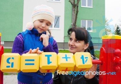 Mom And Daughter Playing On The Playground Stock Photo