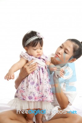 Mom Is Holding And Playing With Her Baby On White Background Stock Photo