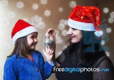 Mother And Daughter In Christmas Capsl Stock Photo