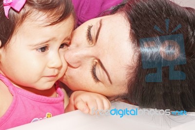 Mother Kissing Her Daughter Stock Photo