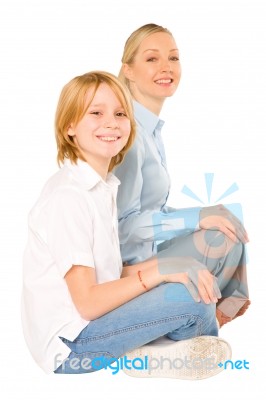 Mum And Son Sat On The Floor Smiling Isolated On White Backgroun… Stock Photo