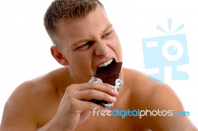 Muscular Guy Eating Chocolate Stock Photo
