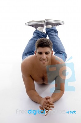 Muscular Male Model Lying And Looking At Camera Stock Photo