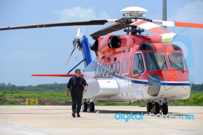 Offshore Helicopter Pilot Is Walking And Smiling Beside Of S92 H… Stock Photo