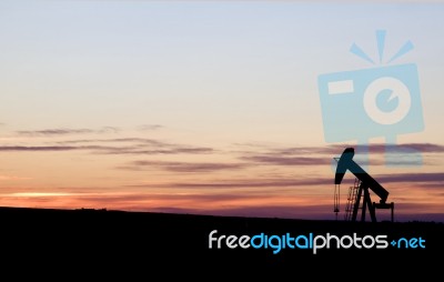 Oil Well At Sunset Stock Photo