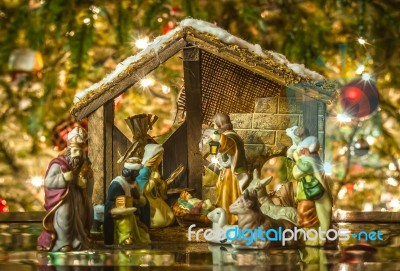Old Handmade Nativity Scene In Front Of A Christmas Tree Stock Photo