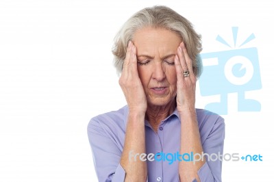 Old Lady Suffering From Headache Stock Photo
