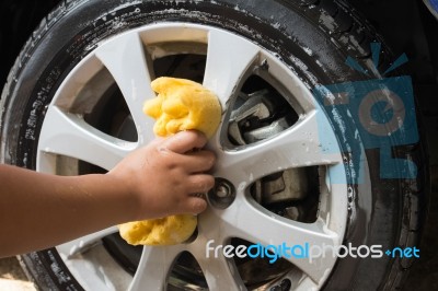 Outdoor Tire Car Wash With Yellow Sponge Stock Photo