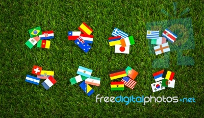 Paper Cut Of Flags On Grass For Soccer Championship Stock Photo