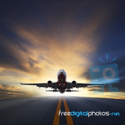 Passenger Plane Take Off From Runways Against Beautiful Dusky Sk… Stock Photo