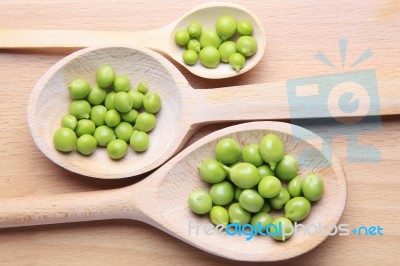 Peas On Wooden Spoon Stock Photo