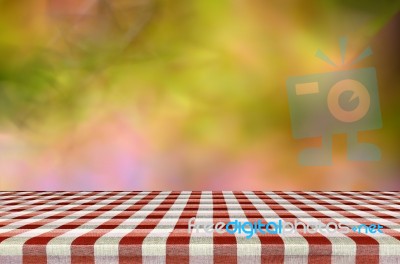 picnic table with blurred autumn leaves background stock photo