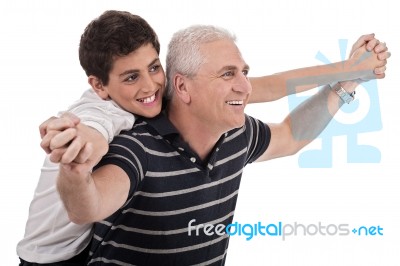 Piggyback Ride Given By Grandfather Stock Photo