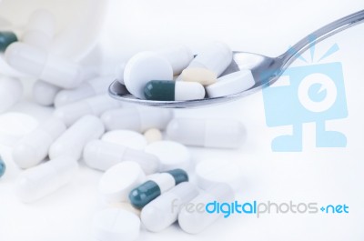 Pills And Tablets On Spoon Stock Photo
