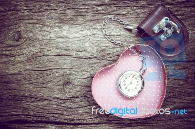 Pocket Watch And Gift In Heart Shape On The Background. Vintage Style Stock Photo