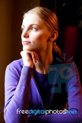 Portrait Of A Young Woman With Hand Under Chin Stock Photo