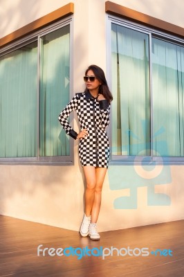 Portrait Of Beautiful Young Woman Wearing Sun Glasses And Short Stock Photo