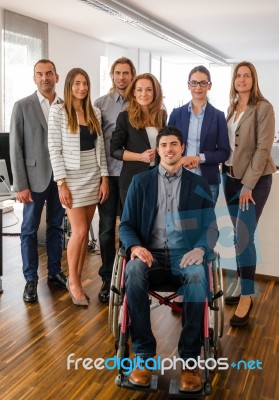 Portrait Of Business Team With Wheelchair Stock Photo