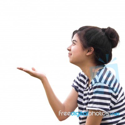 Portrait Of Pretty Young Woman Holding Her Hands Out And Present… Stock Photo