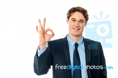 Portrait Of Smiling Businessman Showing Ok Sign Stock Photo