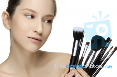Portrait Of The Beautiful Woman With Make-up Brushes Stock Photo