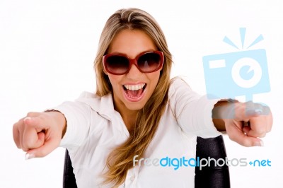 Portrait Of Young Female With Sunglasses Pointing With Both Hands Stock Photo