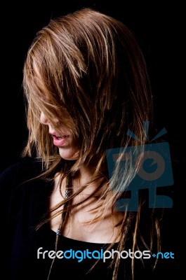 Portrait Of Young Woman Hiding Her Face With Hair Stock Photo